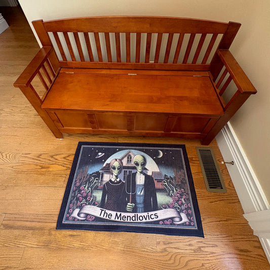 Wooden bench with a mat featuring aliens and personalized text on a wooden floor.